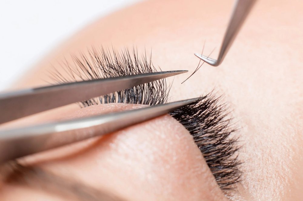 Lash artist applying eyelash extensions