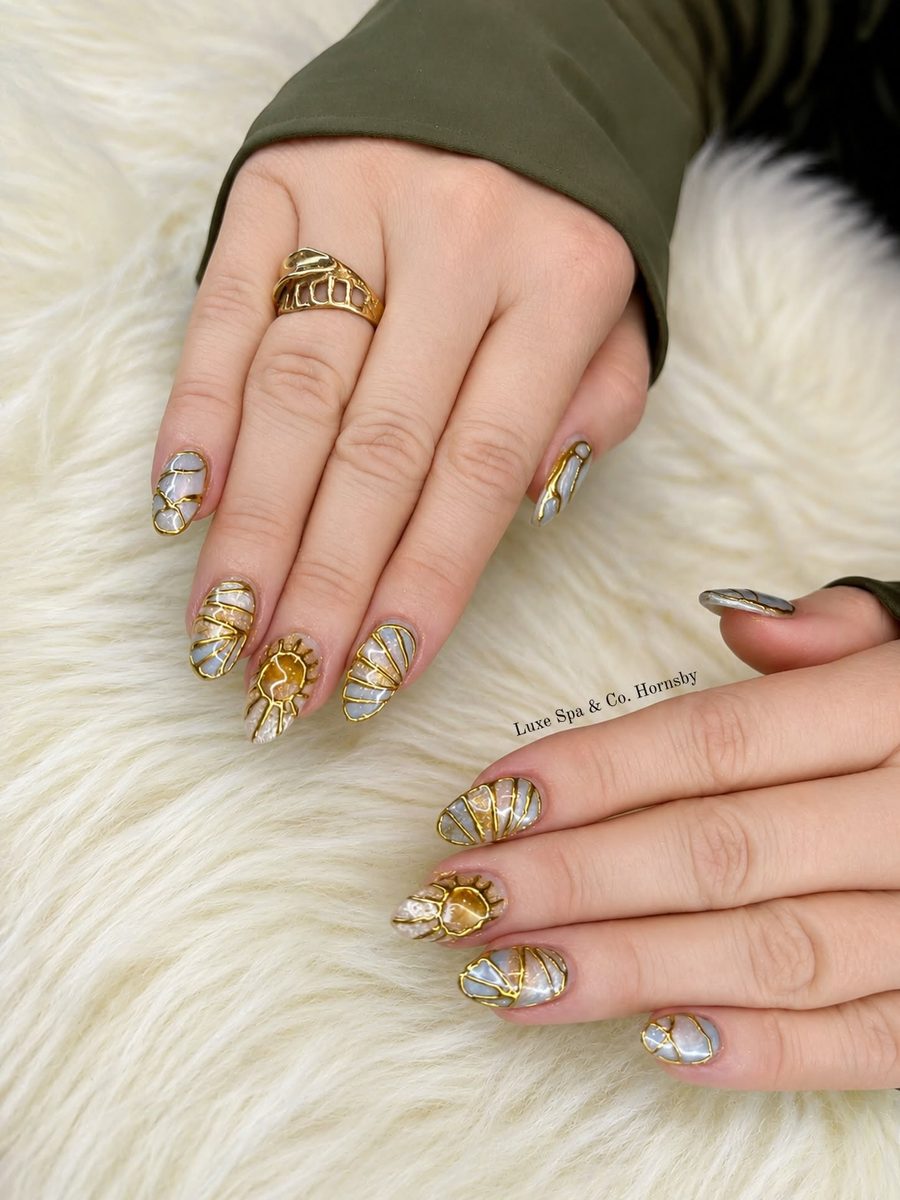 Nude nails with gold foil accents