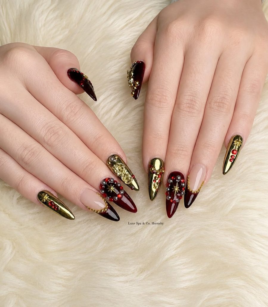 Deep cherry and gold stiletto nails